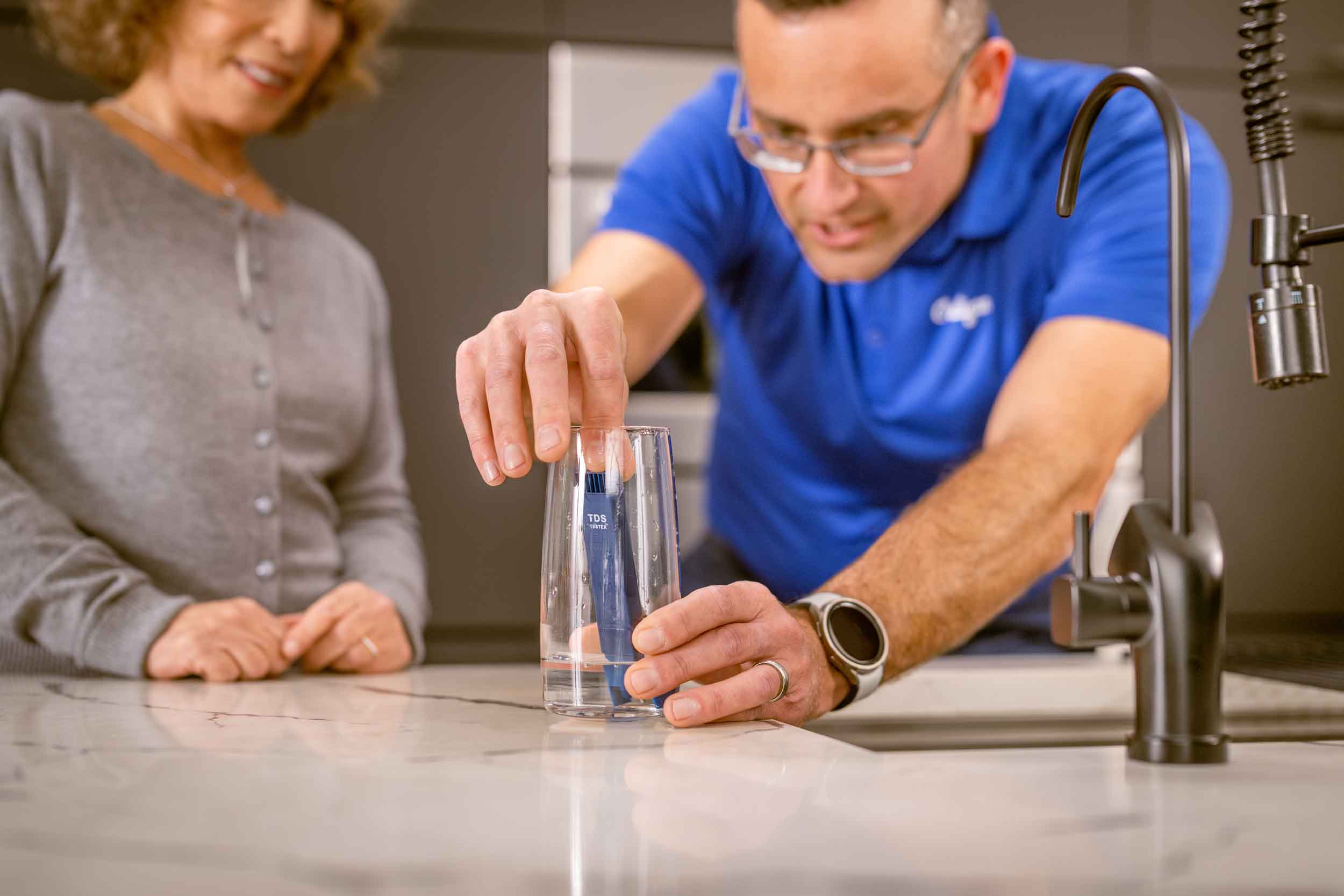 Culligan man performing in-home water test for a customer.