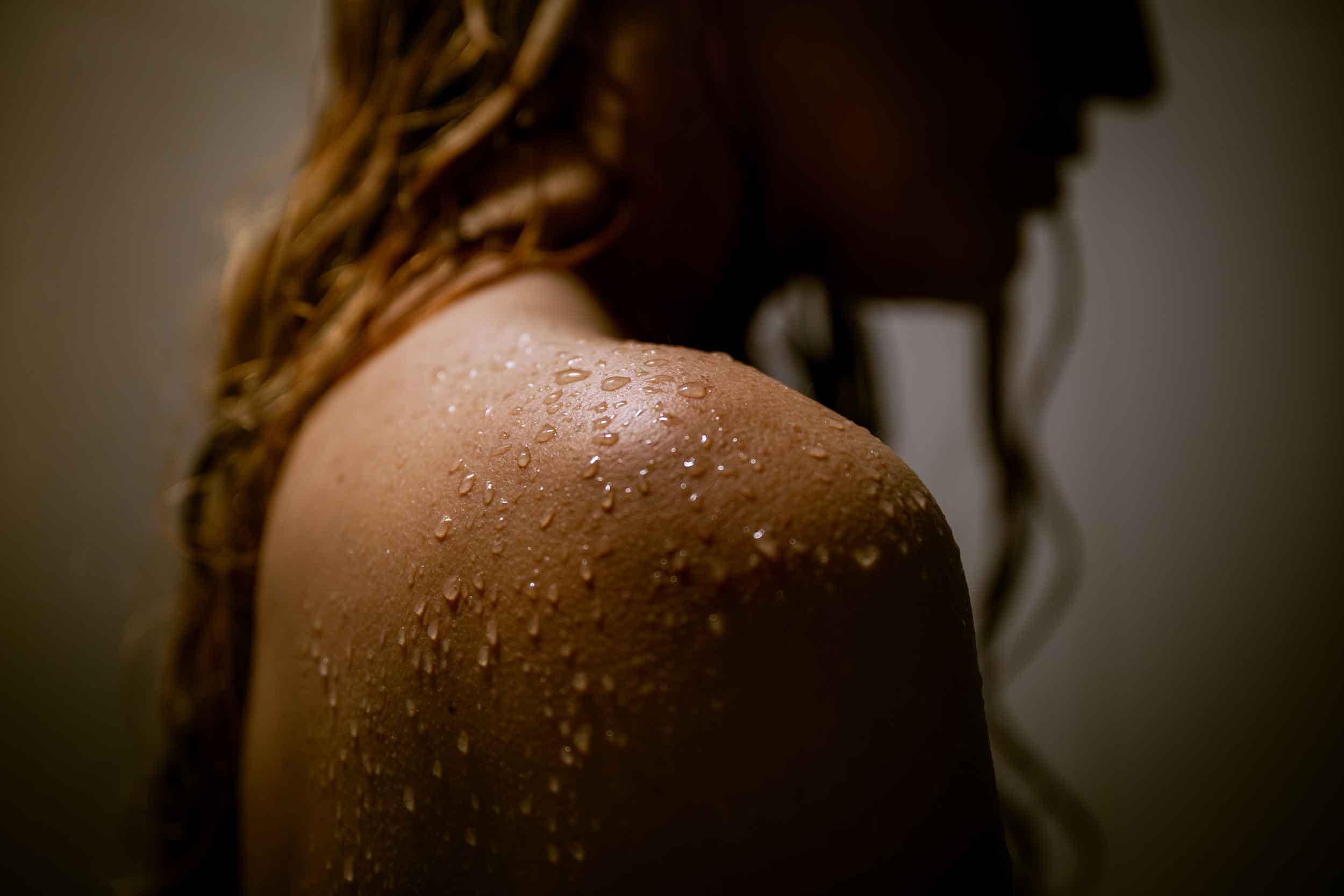 Water Softeners, Culligan Water Seymour Indiana Woman in shower with a water shoulder in focus.